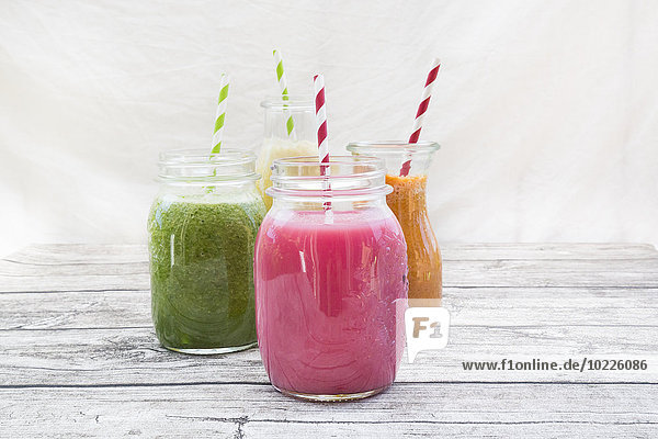 Four glasses of different smoothies