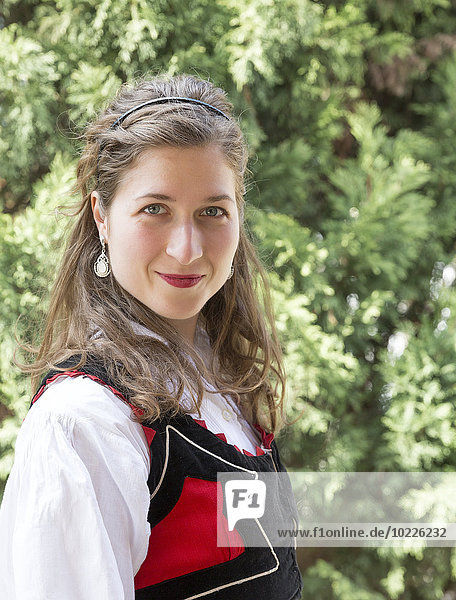 Portrait of smiling woman wearing traditional Hungarian costume