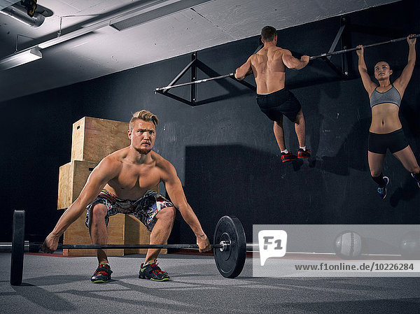 Three CrossFit athletes at workout