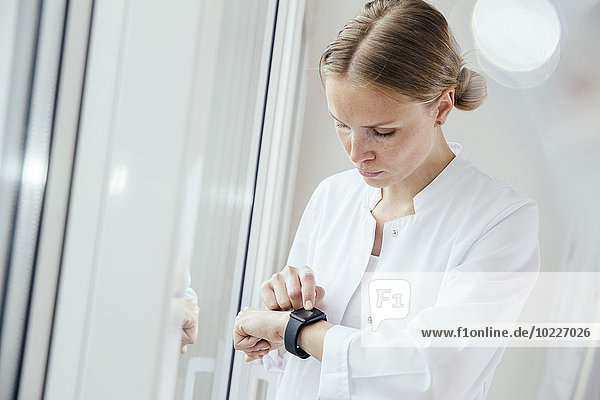 Female doctor looking on her smart watch