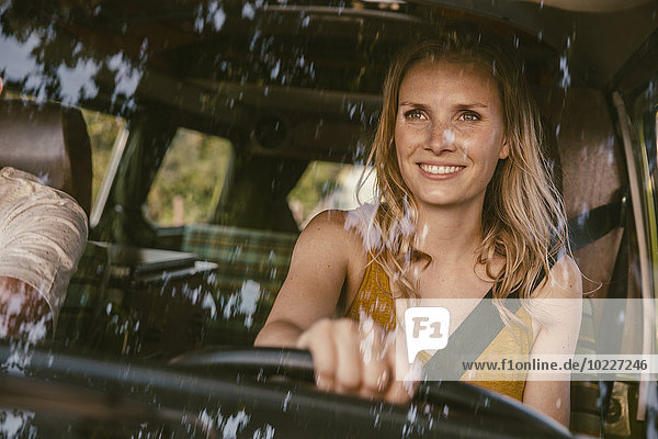 Smiling woman driving van