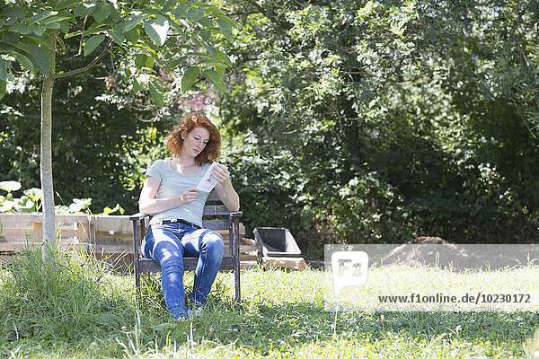 Young woman reading in garden
