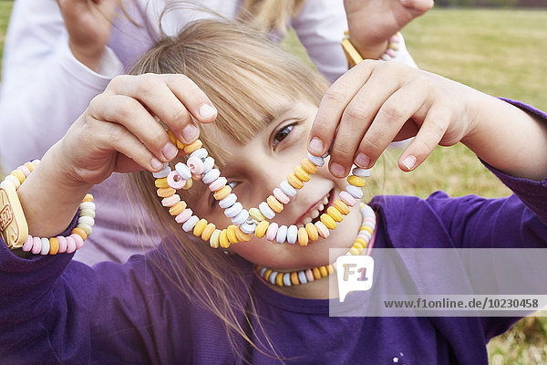 Little girl with necklace and bracelet made of Hundreds and Thousands