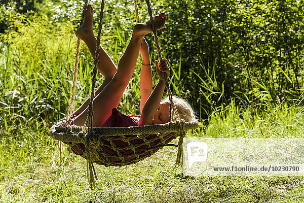 Girl relaxing in nest swing