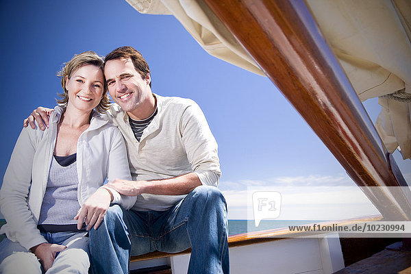 Happy mature couple on a sailing ship
