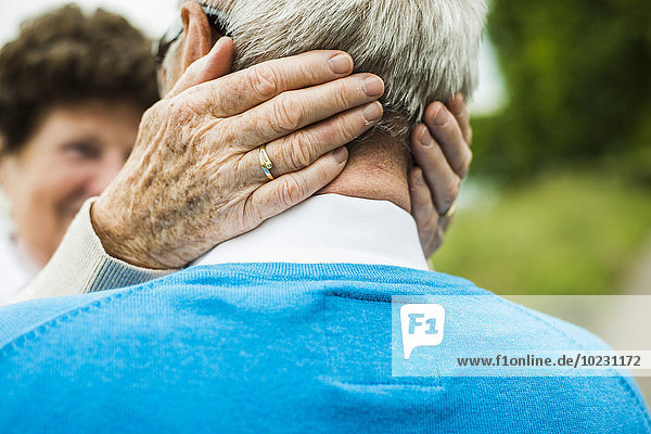 Senior woman embracing her husband  close-up