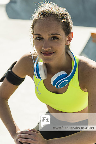 Portrait of sportive young woman with blue headphones