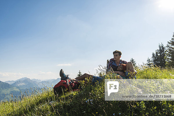 Austria  Tyrol  Tannheimer Tal  young couple resting on alpine meadow