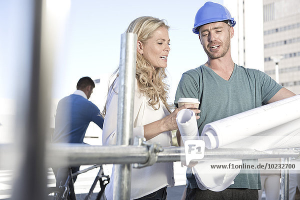 Foreman and architect discussing on construction site