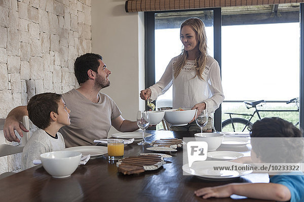 Family having lunch at dining room table