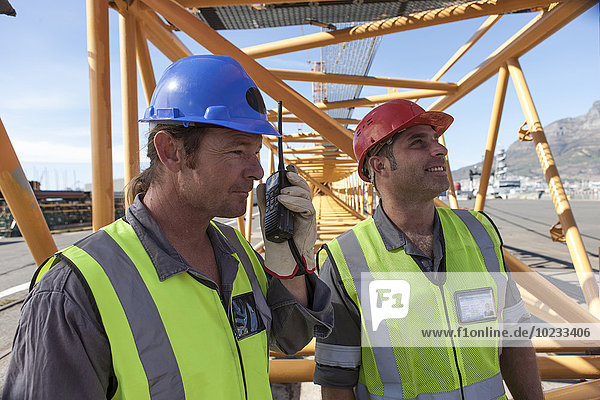 Two workers at port with walkie talkie