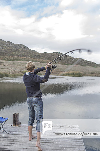 Young man fishing at a lake