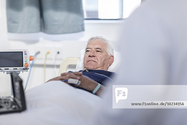 Portrait of senior man lying in a hospital bed