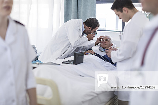 Doctors examining a patient in a hospital