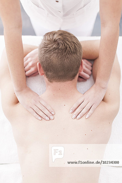 Young man getting a neck massage in a spa
