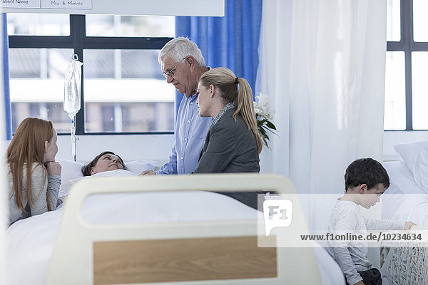 Family visiting mature patient in hospital