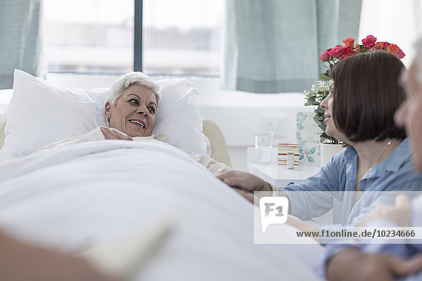 Family visiting senior patient in hospital