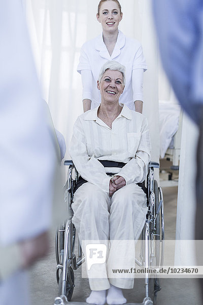 Nurse with elderly female patient in wheelchair