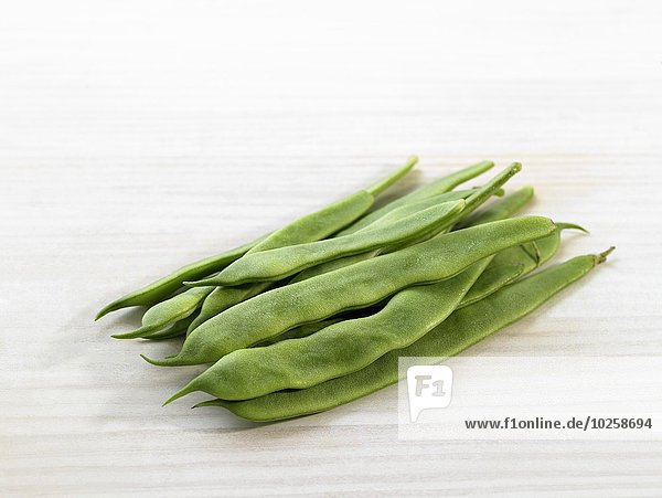 Runner beans on a white background