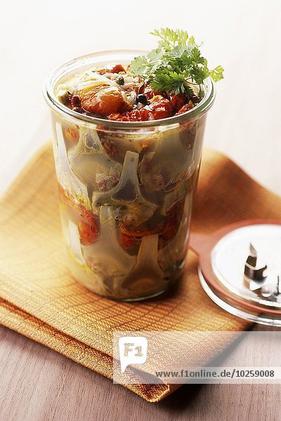 Jar of artichokes with sun-dried cherry tomatoes
