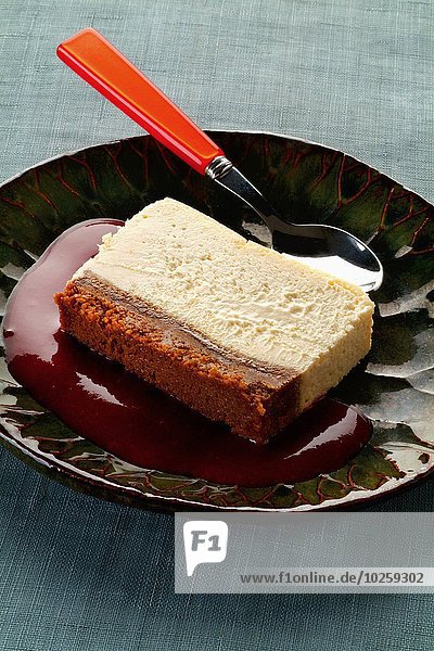 Slice of lemon cheesecake with strawberry puree