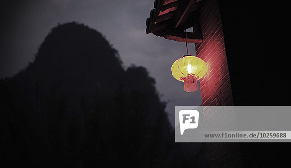 Low angle view of Chinese lantern hanging on house roof at night  Huanggyao  China