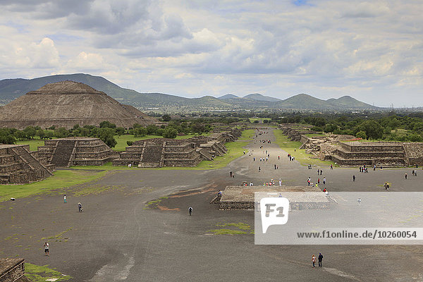 High angle view of people on street by Pyramid of the Sun against cloudy sky