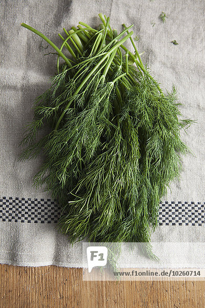 High angle view of dill leaves on cloth