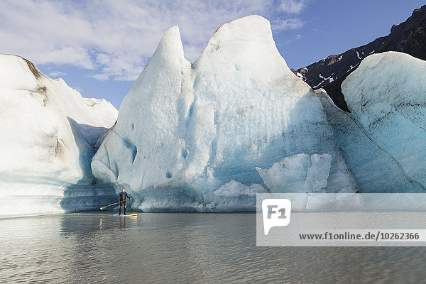 One Person stand up paddleboarding in front of Grewingk Glacier  Kachemak Bay State Park  Southcentral Alaska