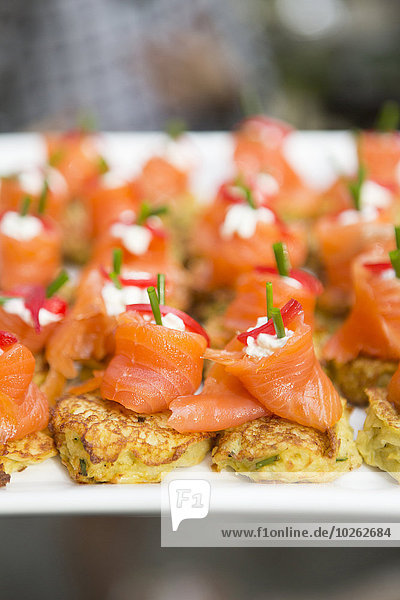 Close-up of Salmon with Cream Cheese and Red Pepper on Pancake Appetizer