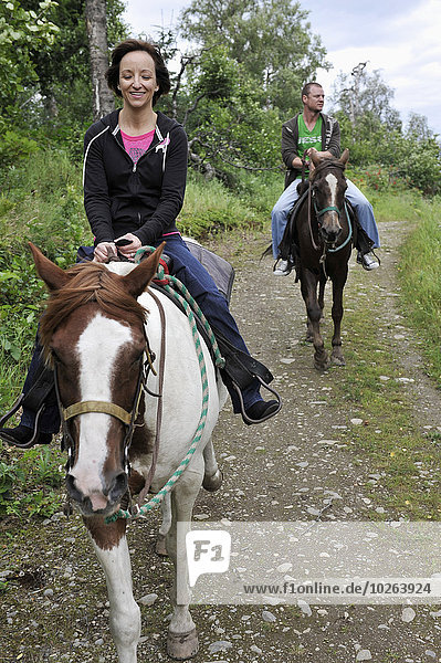 Tourists on a trail ride with Horse Trekkin Alaska in Far North Bicennentenial Park Anchorage  Southcentral Alaska