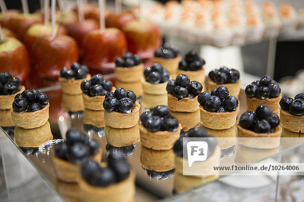 Close-up of dessert platters with blueberry tarts  at an event  Canada