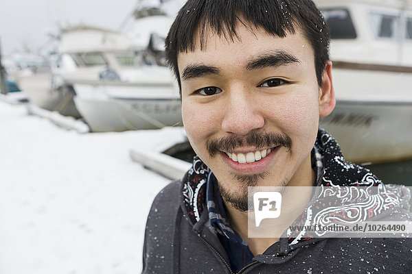 Portrait of an Alaskan native man in front of the Homer small boat harbor  Homer Spit  Southcentral Alaska