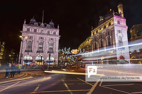Bus and car headlight trails  Piccadilly Circus; London  England