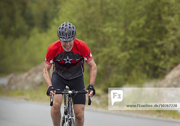 Senior male cyclist wearing helmet; Vancouver Island  British Columbia  Canada