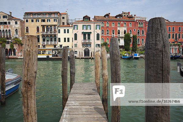 Colourful buildings on the Grand Canal from a dock; Venice  Italy