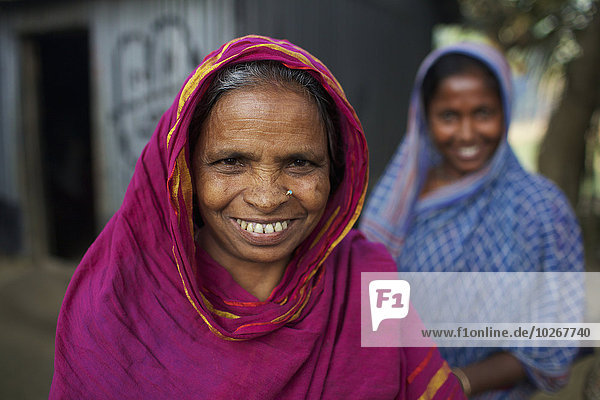 Portrait of a senior woman with daughter in background; Kishoreganj  Bangladesh