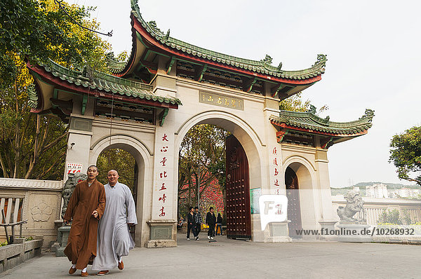 Two monks leaving Nan Pu Tuo buddhist temple; Xiamen  Fujian Province  China