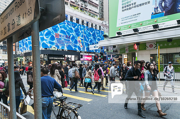 Pedestrians crossing the road  Kowloon; Hong Kong  China