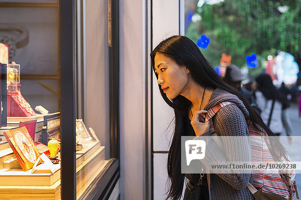 junge Frau junge Frauen Fenster Straße kaufen Handel Laden vorwärts