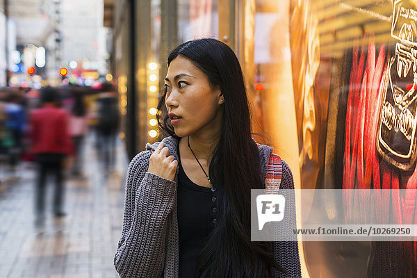 A young woman shopping along the street  Kowloon; Hong Kong  China