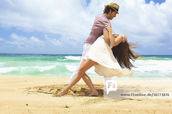 'Couple dancing on the beach; Kealia  Kauai  Hawaii  United States of America'