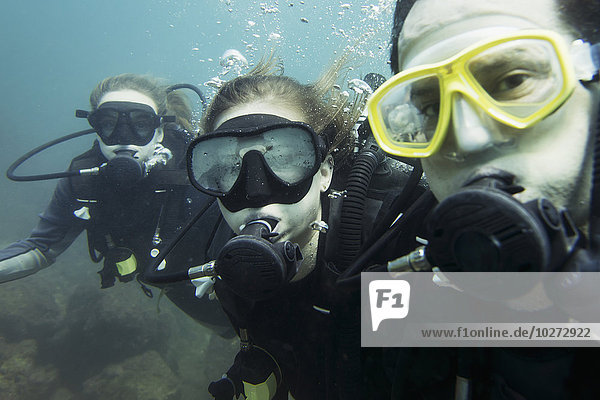 'Scuba divers posing underwater; Ixtapa-Zihuatanejo  Guerrero  Mexico'