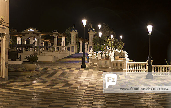 'Lampposts illuminated along the promenade at nighttime; Benidorm  Spain'
