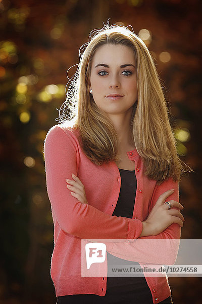 'Portrait of a young woman with arms crossed  looking confident; United States of America'