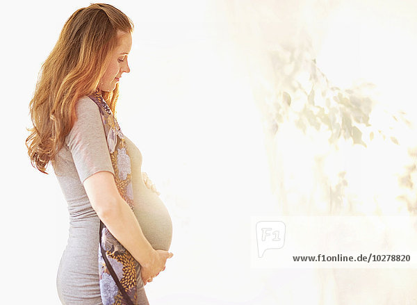 Side view of pregnant woman outdoors