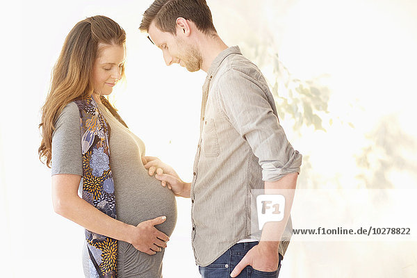 Pregnant woman holding hands with her boyfriend
