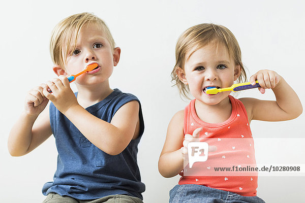 Children (2-3) brushing teeth
