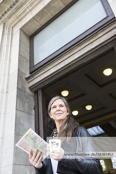 Smiling woman holding map