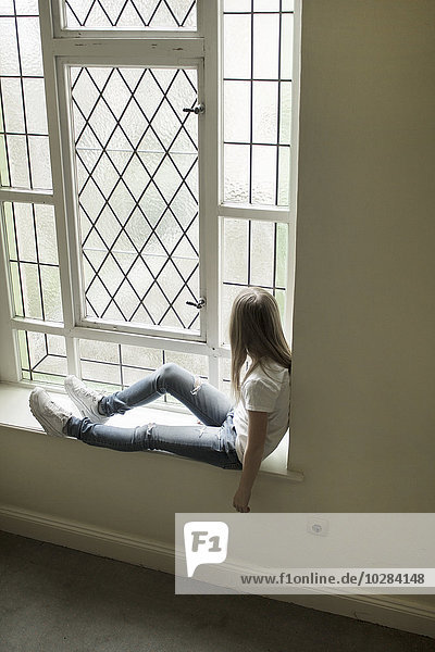 Girl sitting on windowsill